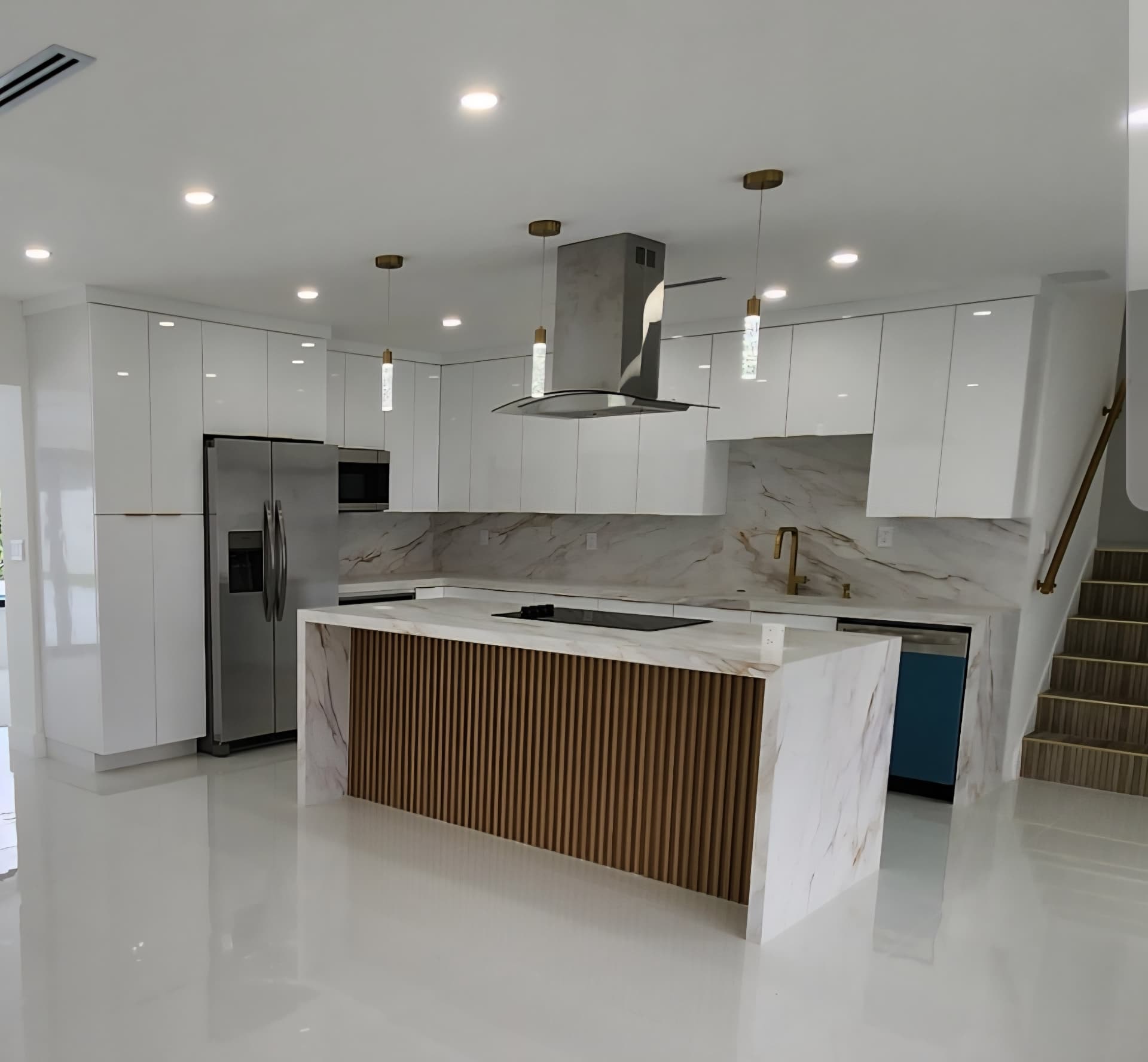 Finished kitchen remodel with white cabinets and a quartz island